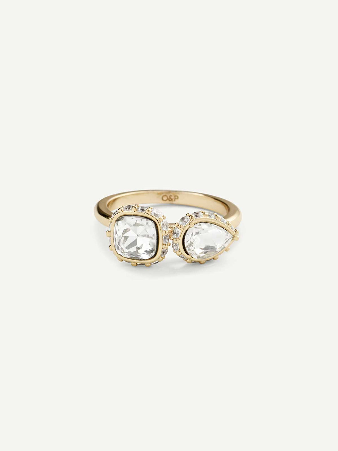 Gold ring with two clear gemstones on a white background