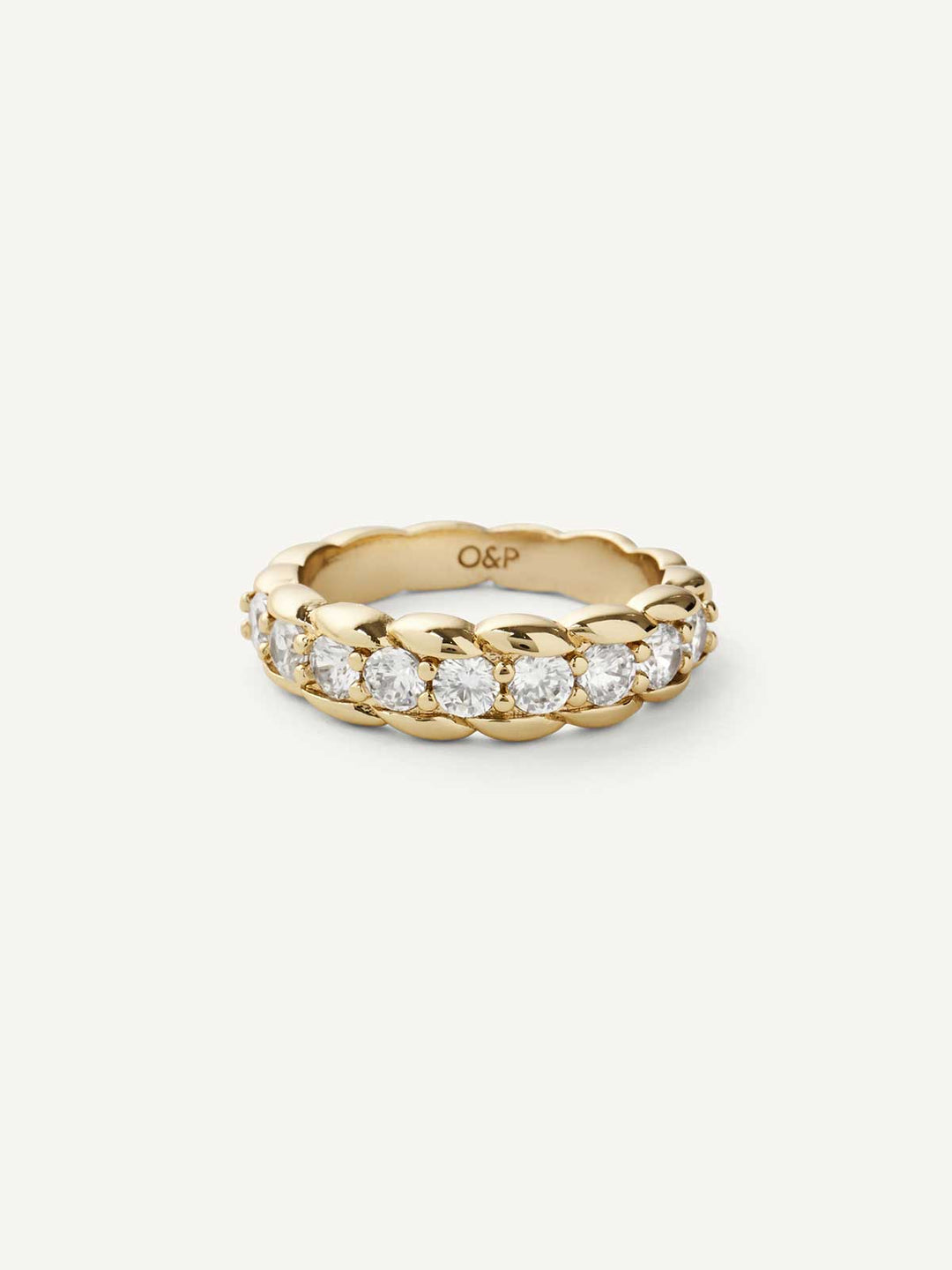 Gold ring with clear gemstones on a white background