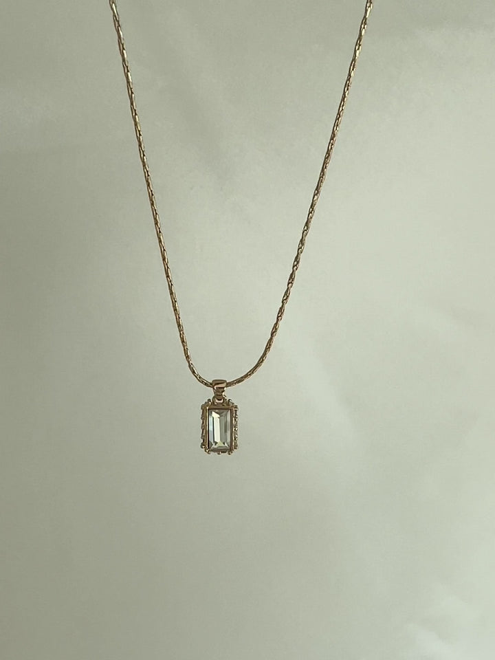 Gold necklace with a rectangular pendant 
